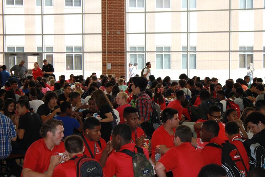 Students eat in the large cafeteria of Judson High School. The campus must have 4 lunches to accommodate all of the students.