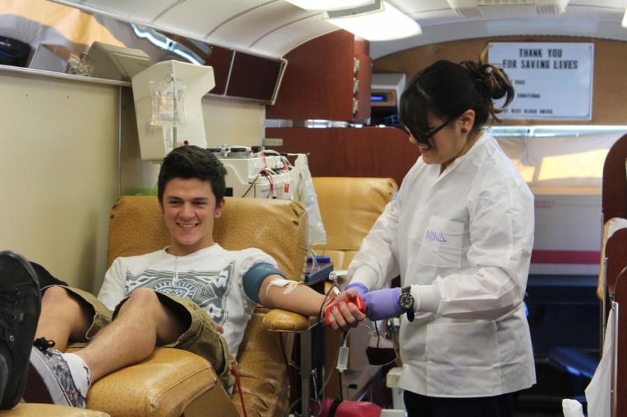 A Judson student gives blood in the mobile blood center.