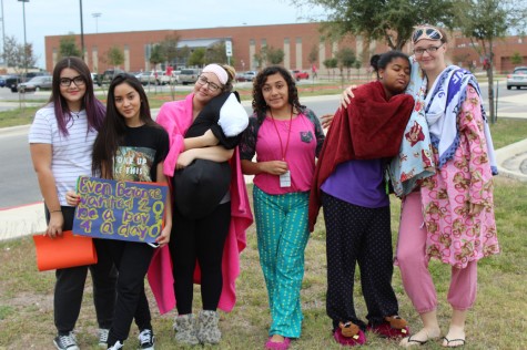 Students stand in front of the school to promote the sale of the yearbook.