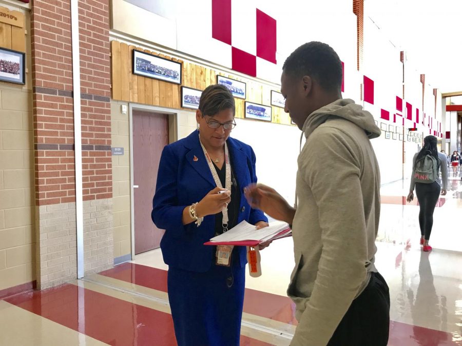 Carter signs student’s form in the hallway. Carter attended Judson herself and graduated in the class of 1991.