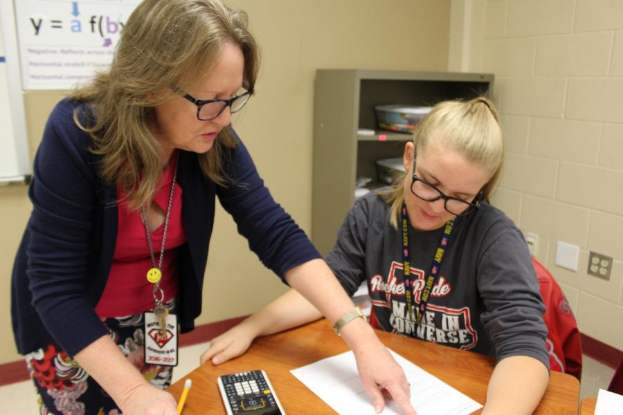 Mrs. Brenda Milam helps a student with her classwork during one of her AP Calculus periods. Milam has been teaching at Judson High School for 32 years.