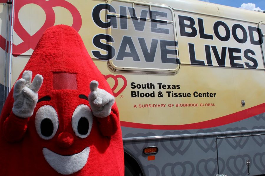 The blood drive mascot stands by the blood mobile, to encourage donating blood. Every year, Judson holds the blood drive through three different organizations throughout the year and has been doing this for 25 plus years.