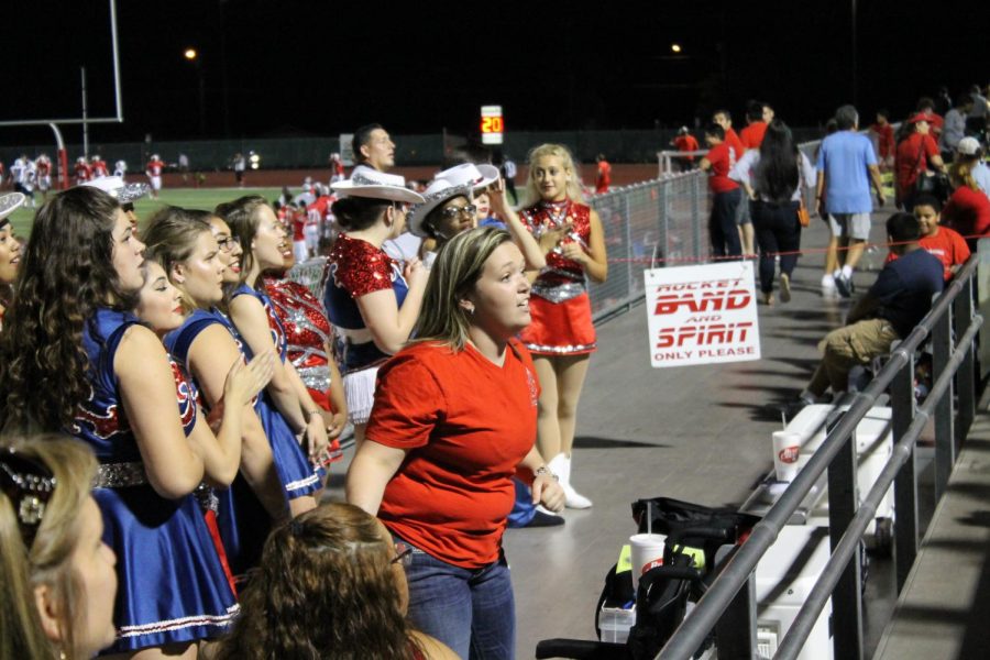 Ms. Lauryn McCarthy coaches her dancers during a football game at D.W. Rutledge Stadium. This is her second year as director of the organization.