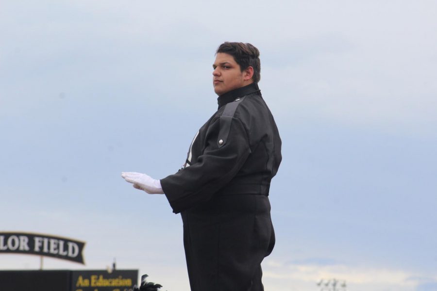 Junior Lonnie Buck looks out towards the field as he conducts. This is Buck’s first year as a drum major.