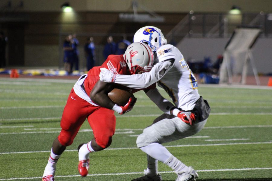 Senior Sincere McCormick fights against the Clemens tackle for extra yards. Rockets secure the undefeated season against the Buffalos. 