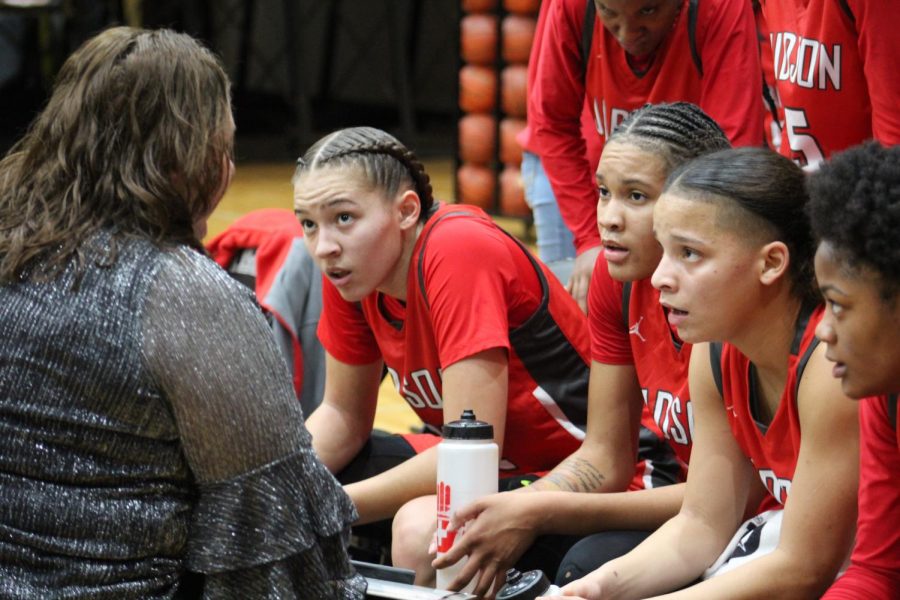 Coach Corrales instructs her starting five during a timeout. Rockets went on to win 63-46.