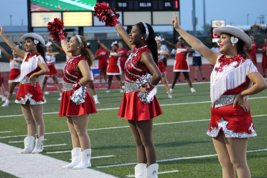 The dancers stand at attention before a football game at D.W. Rutledge Stadium. The move to combine the teams will make one varsity team and one true JV team.