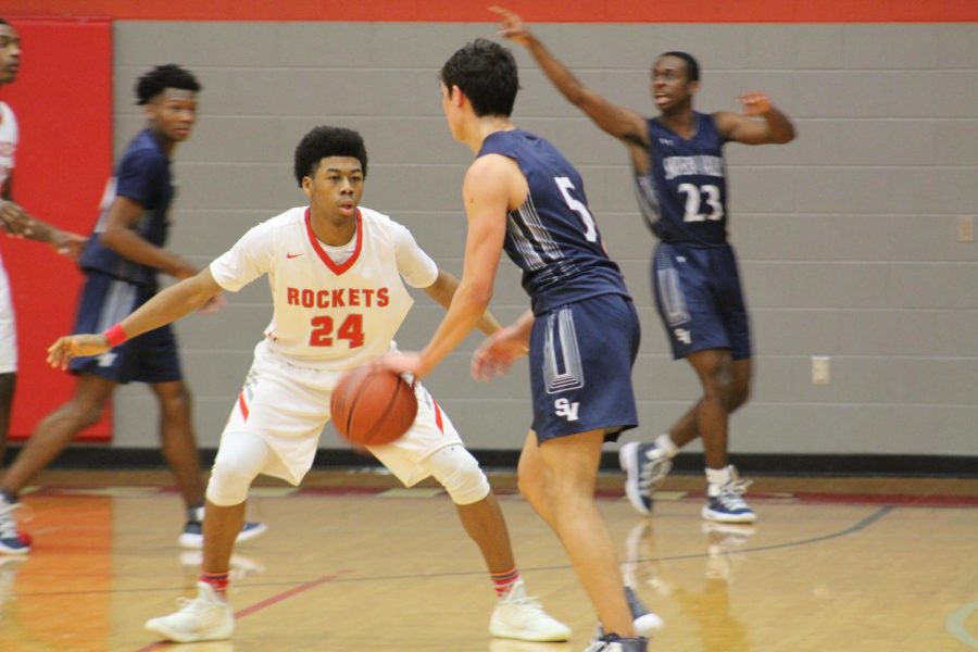 Junior Ambrose Johnson plays defense against the Rangers guard. Rockets took the win with a score of 53-49.