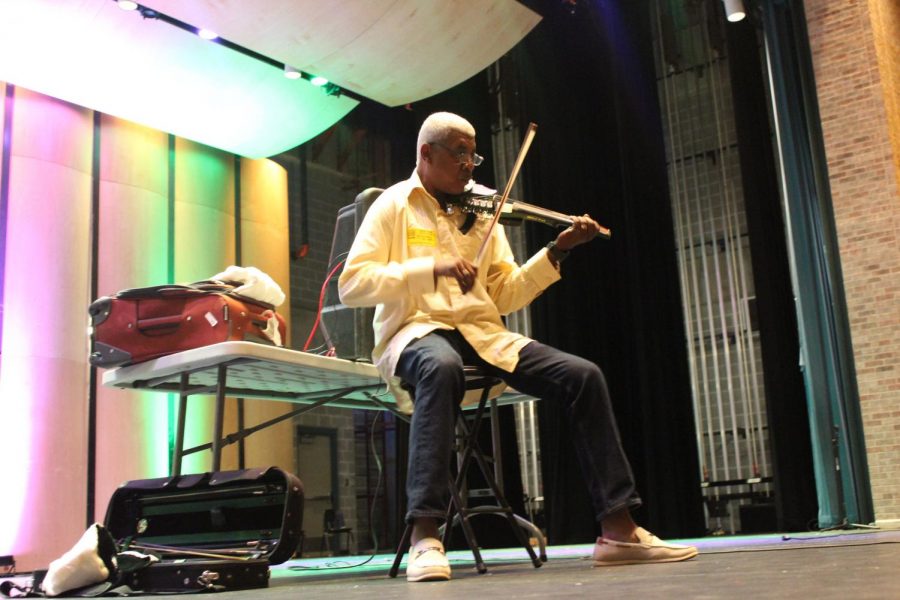 World-renowned musician Michael Ward plays his violin in front of band and orchestra members in the Performing Arts Center. Ward has traveled all over the world playing concerts for high profile people.