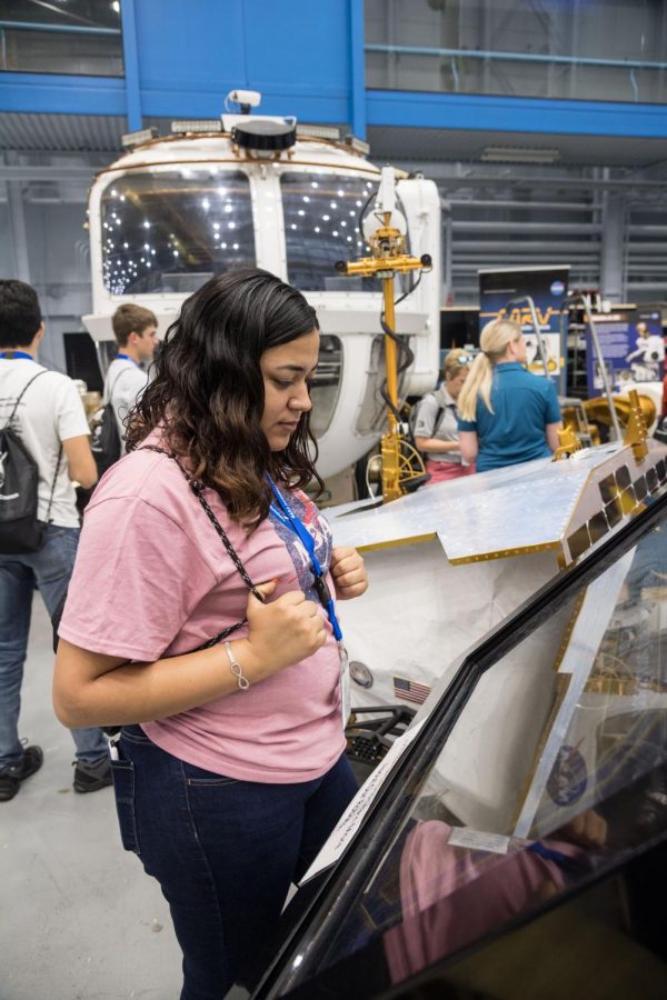 Senior Melanie Villarreal looks through a display case at NASAs Johnson Space Center in Houston. She is leading efforts on campus to get others to participate in the program next year.