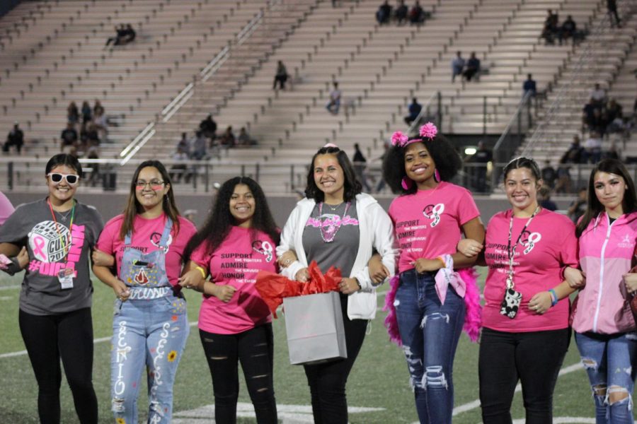 Student Council walks the field after giving their gifts to Smithson Valley during the annual Pink Out game.