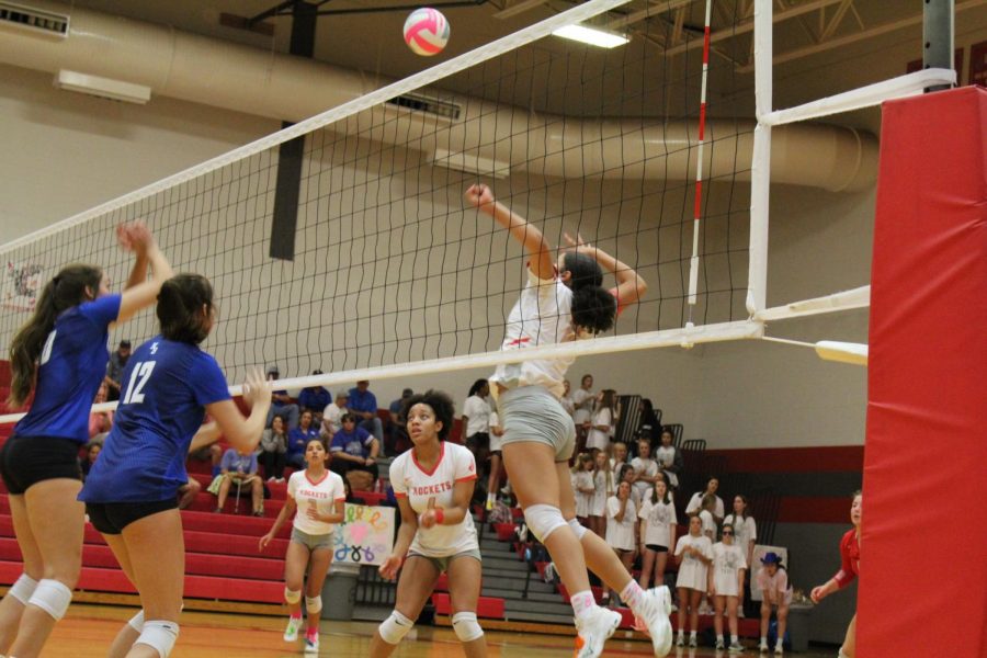 Junior Tatyana Gladden spikes the ball againsts New Braunfels during their annual Pink Out game.