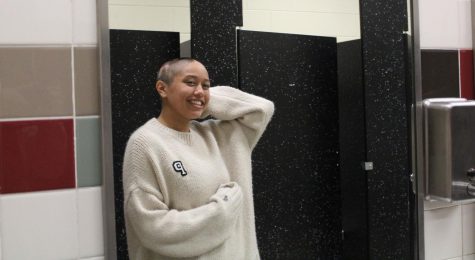 Victoria Villaflor beautifully poses in front of the mirror. She recently shaved her head due to her Alopecia condition. The swim team showed their support for their teammate during this tough time.