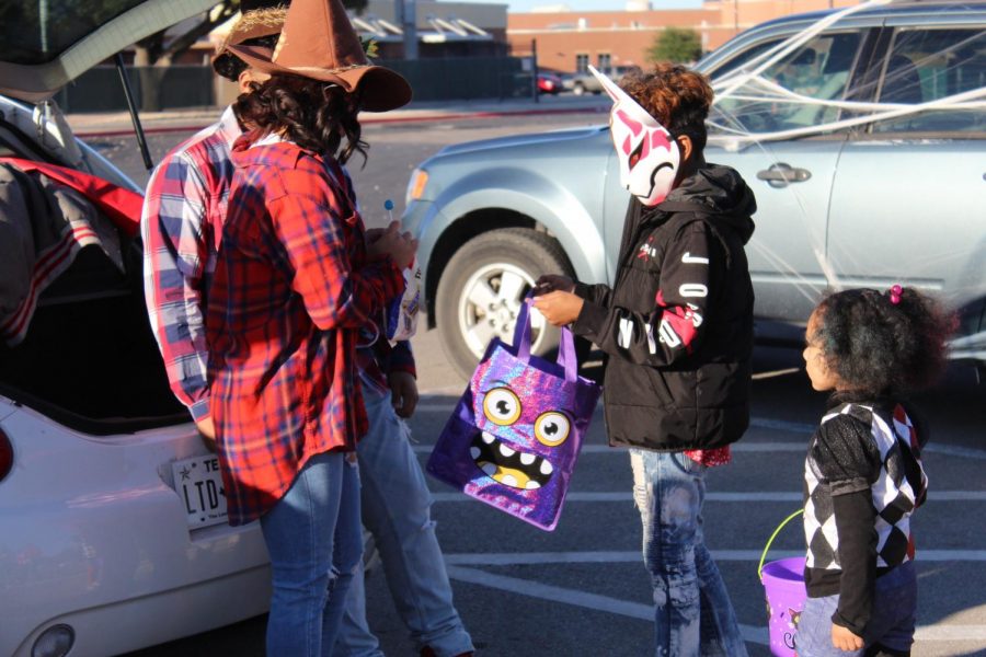 Neighborhood children come up to cars sponsored by campus organizations at the first annual Trunk or Treat.