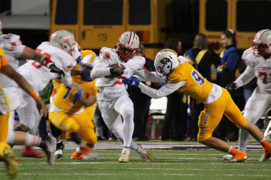 Senior Mike Chandler runs the ball through the Clemens defensive line. Even though they lost the game, the Rockets will still head into the playoffs againsts Hays this Friday.