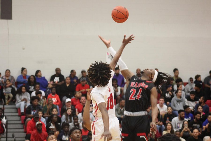 Senior Ja’Kolby Cornelius and Wagners Journee Philips tip off at the first boys basketball game of the season. The Rockets fell to the Thunderbirds, 57-75.