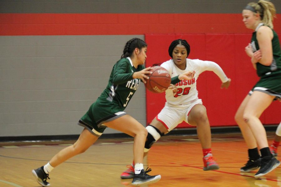 Junior Kierra Sanderlin defends a Rattler basketball player from following through with a point. The Rockets will face the Johnson Jaguars this Friday at the Judson gym.