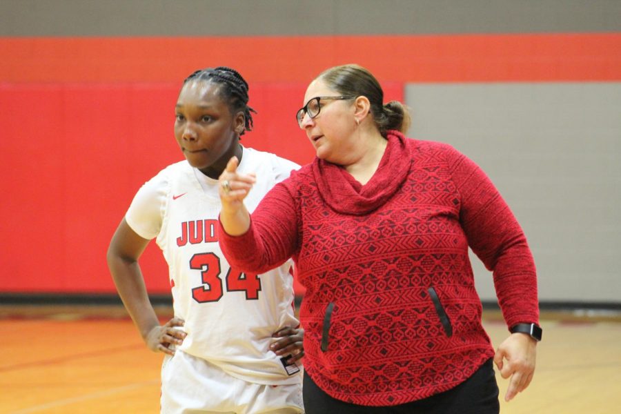 Coach Triva Corales coaches senior Jonmecia Baskin, a key player on the team.