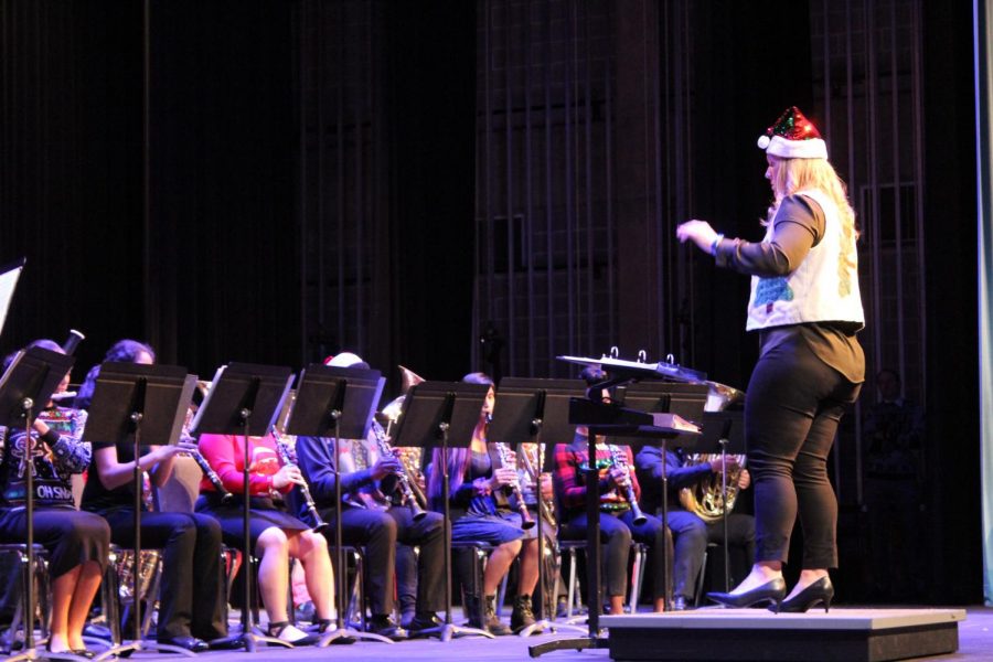 Ms. Laura Poling directs the band during the winter concert at the performing arts center.