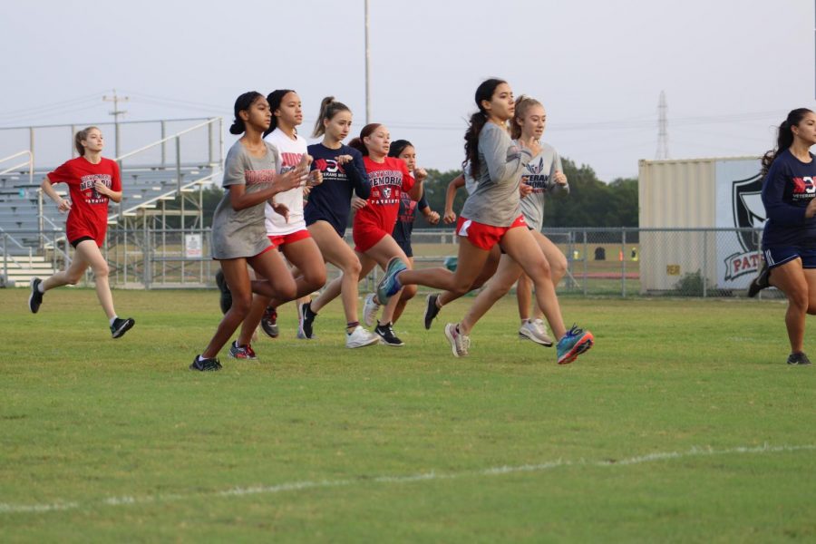 The girls cross country team takes off during their scrimmage run with the team from Veterans Memorial. This was a friendly race between the two as they start their season.