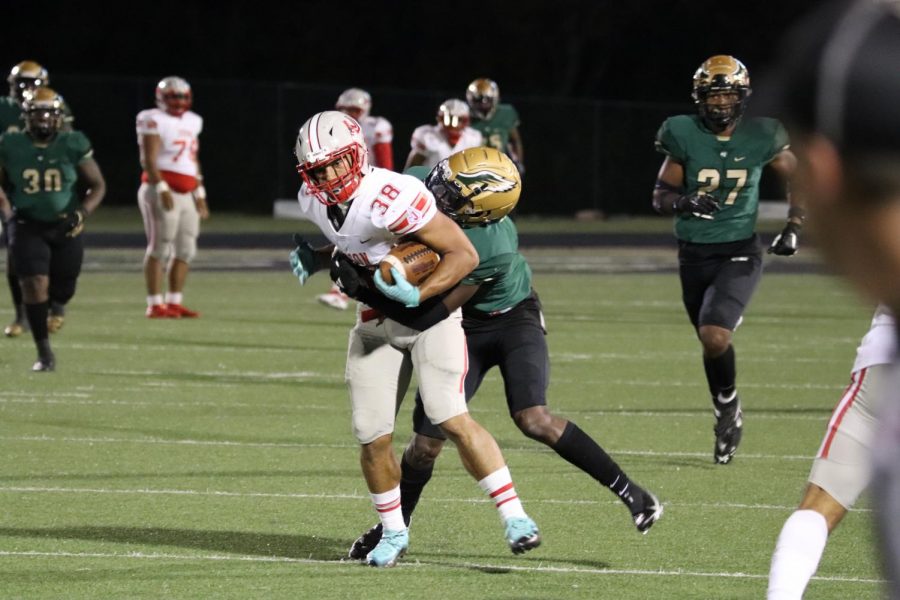 Senior Kameron Lopez fights off a Desoto defender after a catch. The Rockets fell to Desoto 37-0.