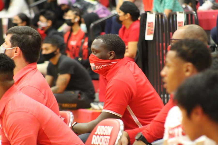 Coach Sheawn Bedford watches his players during the game against Wagner. Not only does he coach for the boys basketball team, but he is also a teacher of psychology.