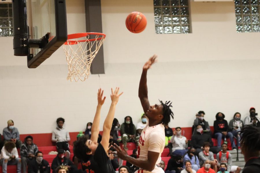 Senior Davion Wilson lays up a shot during the game against Wagner. The boys beat the Thunderbirds in OT, 91-83.