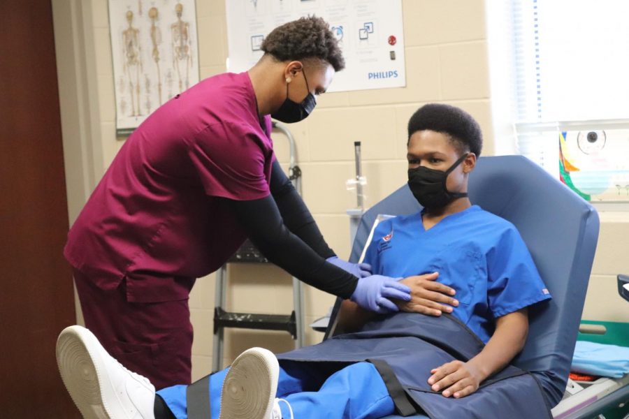Seniors Tristan McDonald and Rashaun Brunson work on skills in the radiology lab. Normally, they would be able to practice skills on sites. But, because of the pandemic, they are restricted to only being able to practice those skills on campus.