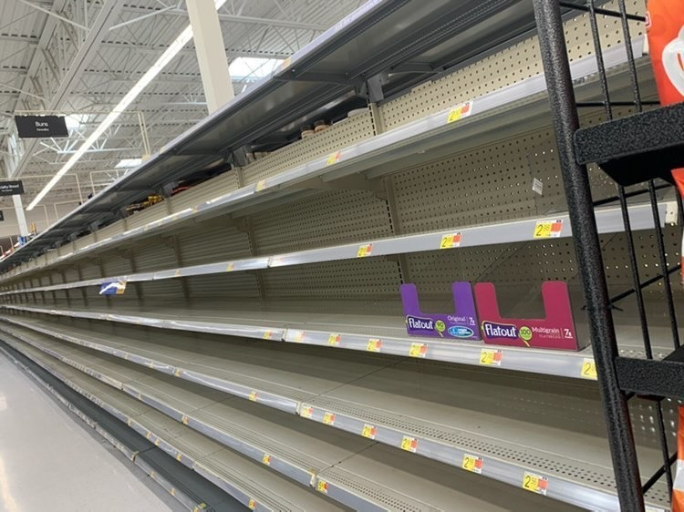 Senior Ronald Waiter takes a picture of an empty grocery store aisle. HEB, a Texas grocery store, was cleared out before and during the snow storm event in Texas. However, they have been praised for their preparedness before, during, and after the storm.