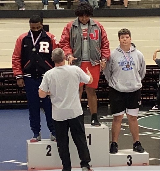 On Saturday, April 10, Coach Guenther congratulates junior Jahire Campos as he earns his district title at the Blossom Athletics Center.