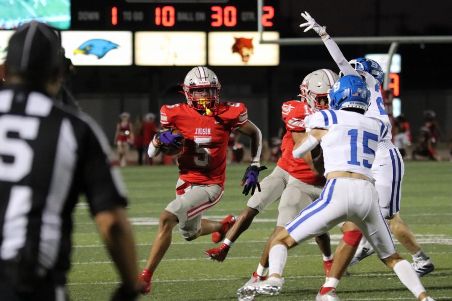 Junior Anthony Evans carries the football downfield towards the zone. Football fell to the Unicorns, 24-21.