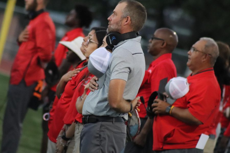 Coach Joel Calls holds his hat on his heart as the national anthem is played during the game against Smithson Valley. This was the first win of his career as head coach, beating Smithson Valley 33-32.