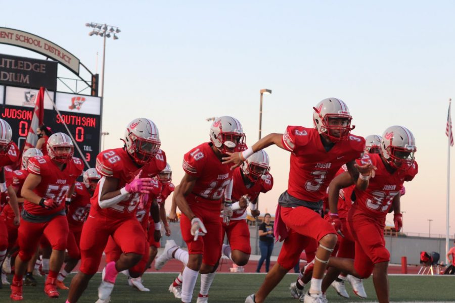 The football team runs out on the field to prepare for their game against South San. They beat the Bobcats, 37-0.