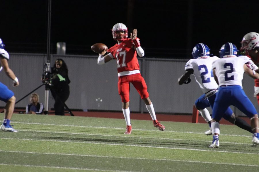 Junior Jaden Castillo throws the ball to a senior Andre Jones during the game against South San. The Rockets earned a much needed win against the Bobcats, beating them 37-0.