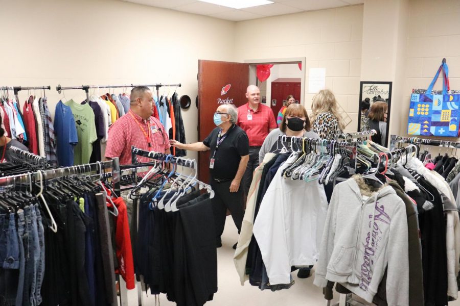 Staff tour the opening of the campus Care Closet. The room is open for any student in need of basic needs.