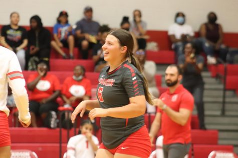 Senior Madalynne Thornton cheers on her team during her game against Steele. She holds the title of captain of the team and libero.