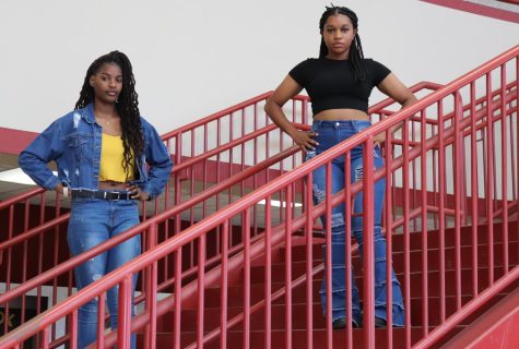 Senior Amira Mabry and junior Queenandra Dunn pose for a photograph in the P Wing stairwell.