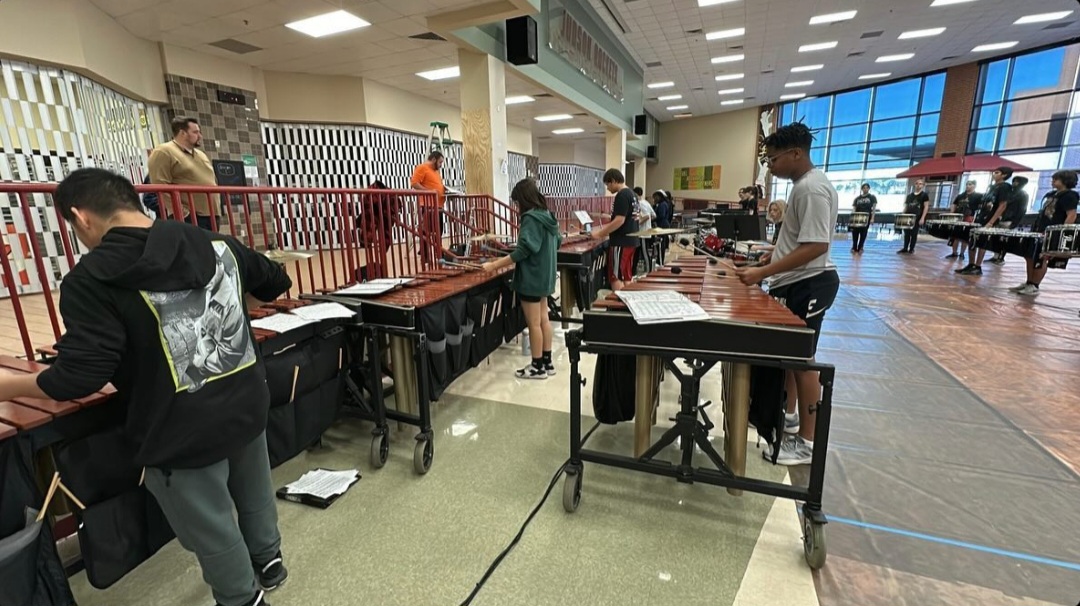 Indoor percussionists practicing their routine in the cafeteria