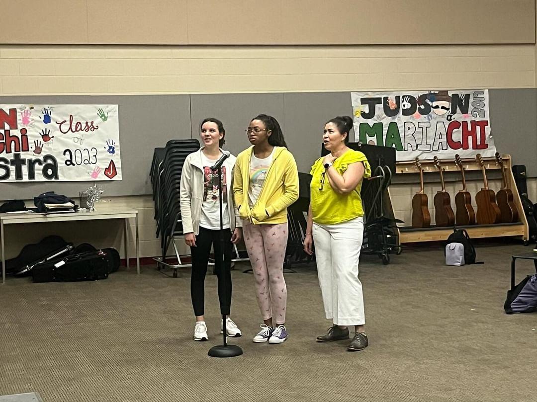 Spanish Honor Society members junior and former exchange student Annika Hattash and junior Treanna Moss sing alongside sponsor Señora Brinson at joint Karaoke Night with Spanish Club and Mariachi