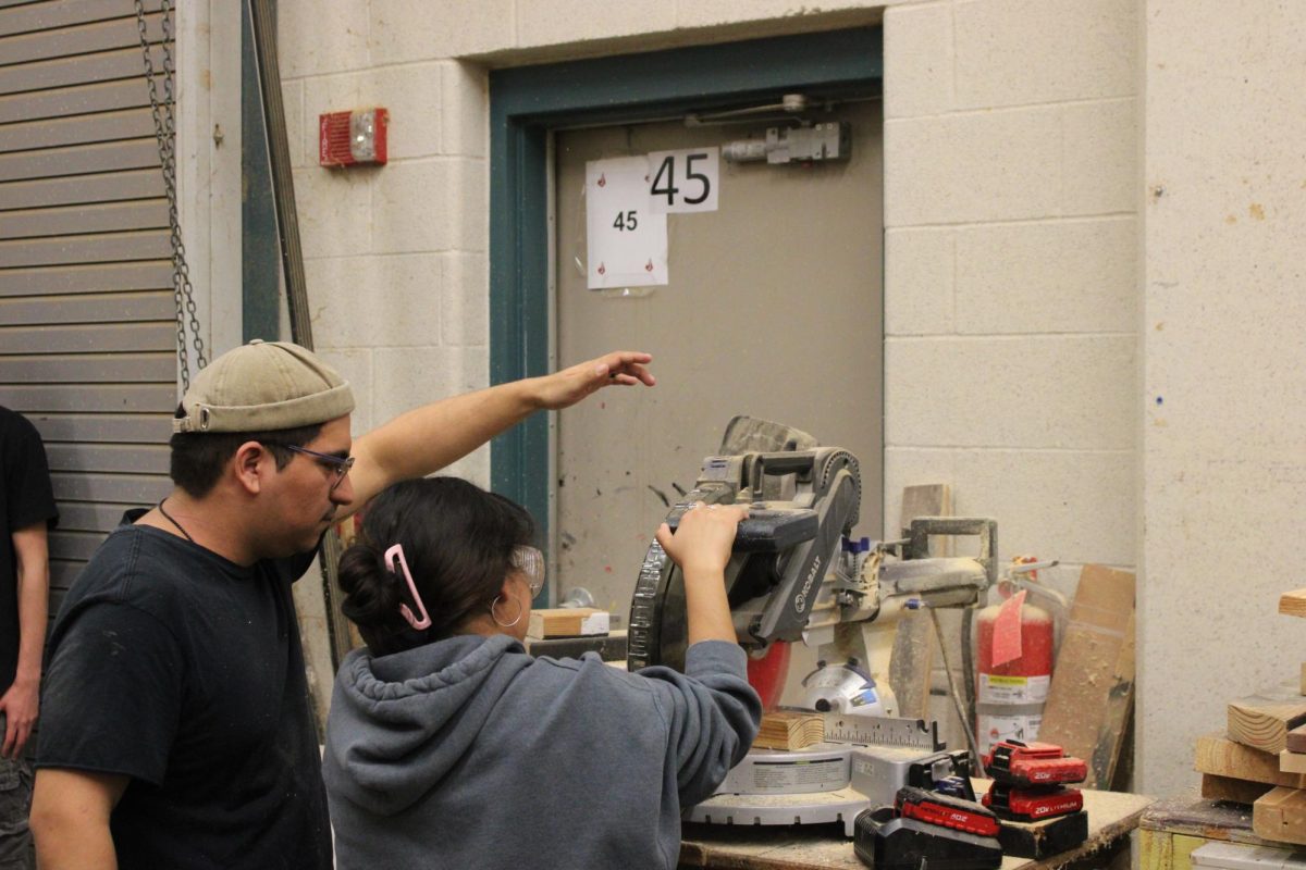 Mr. Mesa shows technical theater students how to operate the workshop equipment used for creating props. 