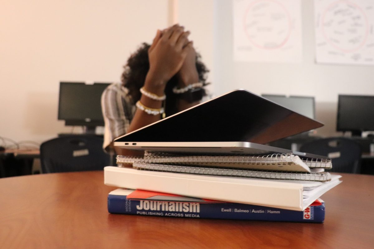 Student stressing out over the huge amount of work in front of him.