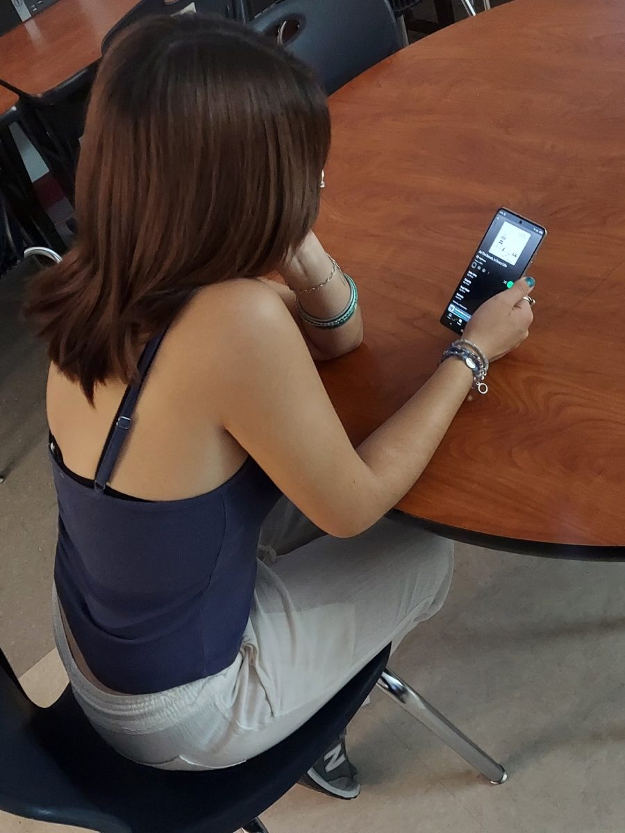 Student listening to "At The Beach, In Every Life" by Gigi Perez.