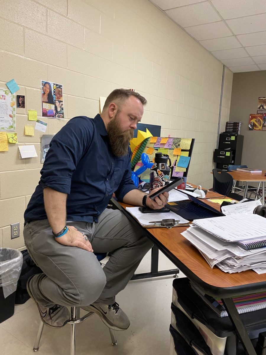 AP Human Geography teacher John Lowrey reads an e-book on his Amazon Kindle in his classroom during his conference period to relax.